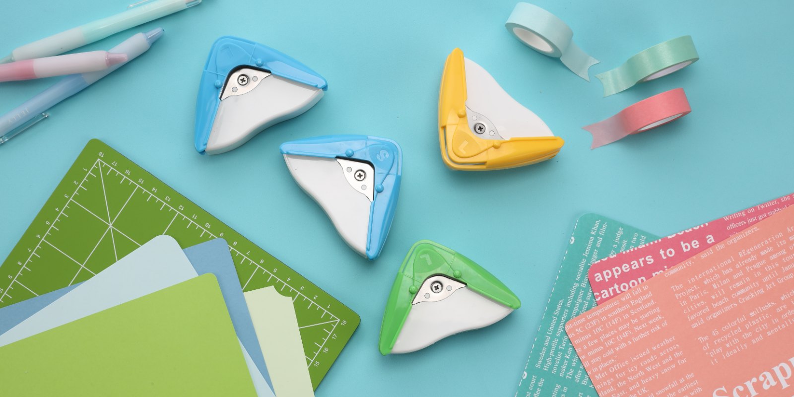aidox 2-in-1 Corner Cutters on a desk with paper, washi tape and a cutting mat